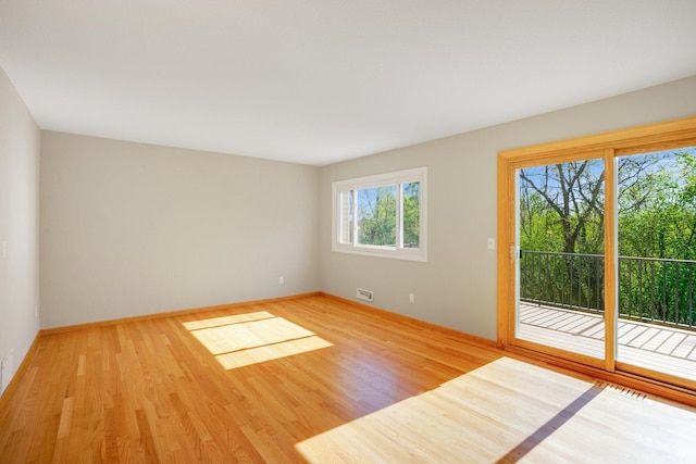 empty room with wood finished floors and baseboards