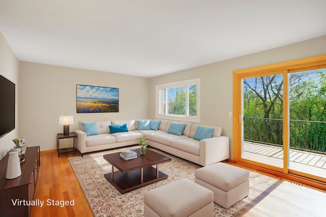 living room with light wood-style flooring and baseboards