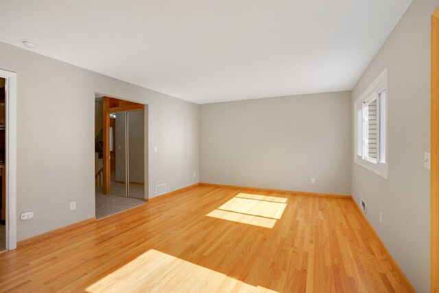 unfurnished room featuring wood finished floors and baseboards