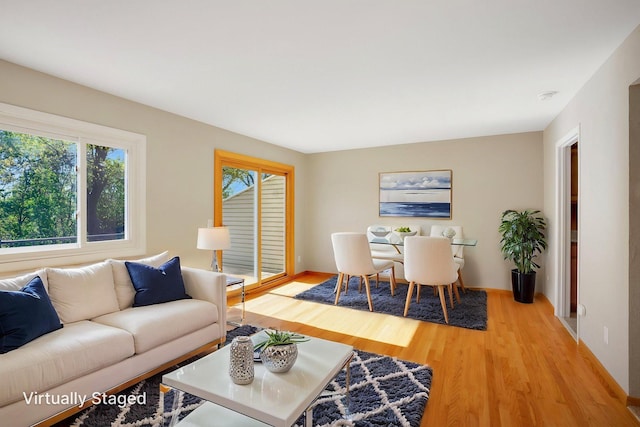 living room featuring light wood-style flooring and baseboards