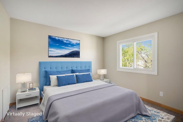 bedroom with baseboards and carpet