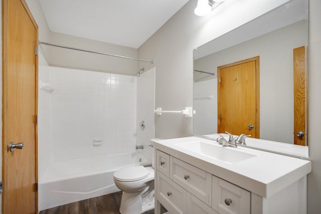 full bathroom featuring wood finished floors, toilet, vanity, and bathtub / shower combination
