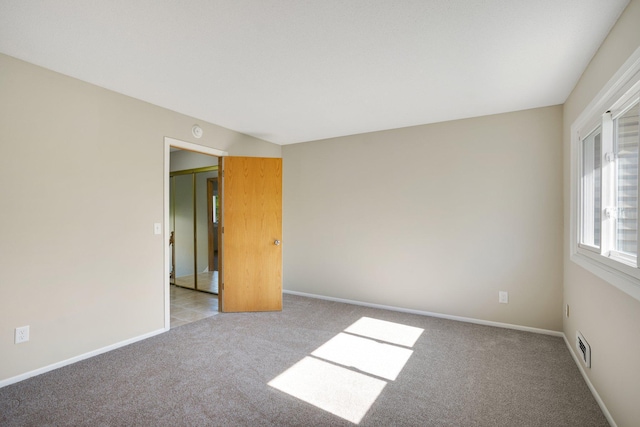 carpeted spare room with baseboards