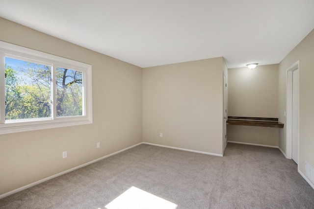 unfurnished bedroom with carpet and baseboards