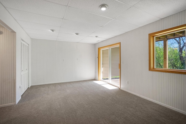 unfurnished bedroom with carpet floors and a drop ceiling
