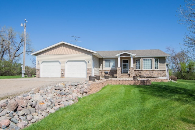 6673 230th St N, Cromwell Twp, MN 56549 - view of front of property featuring stone siding, driveway, a garage, and a front lawn