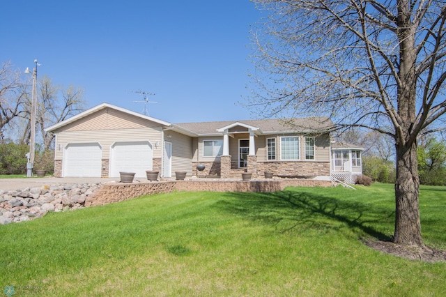 6673 230th St N, Cromwell Twp, MN 56549 - view of front of home with stone siding, a garage, a front yard, and driveway