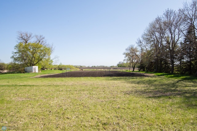 6673 230th St N, Cromwell Twp, MN 56549 - view of green lawn with a shed, an outbuilding, and a view of rural / pastoral area
