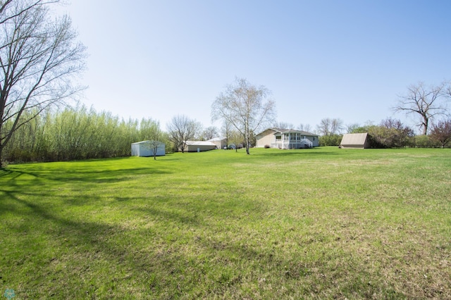 6673 230th St N, Cromwell Twp, MN 56549 - view of green lawn with a detached carport and an outbuilding