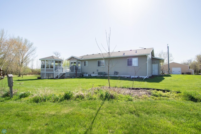 6673 230th St N, Cromwell Twp, MN 56549 - back of property featuring a garage, a yard, a sunroom, and a deck