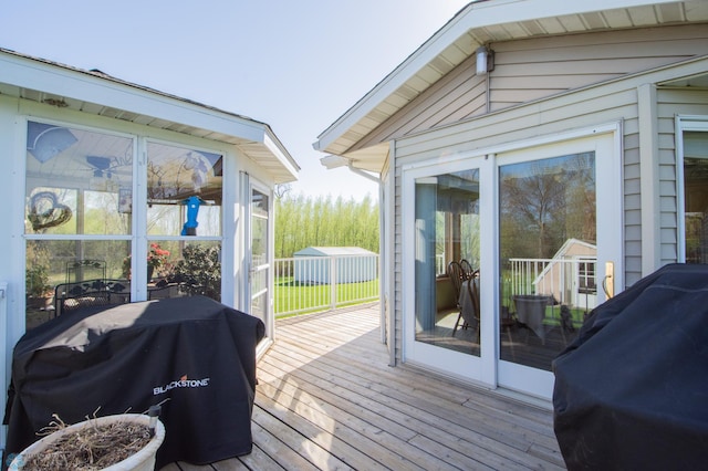 6673 230th St N, Cromwell Twp, MN 56549 - wooden deck featuring a sunroom and a grill