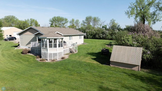 6673 230th St N, Cromwell Twp, MN 56549 - view of green lawn with a sunroom and a deck