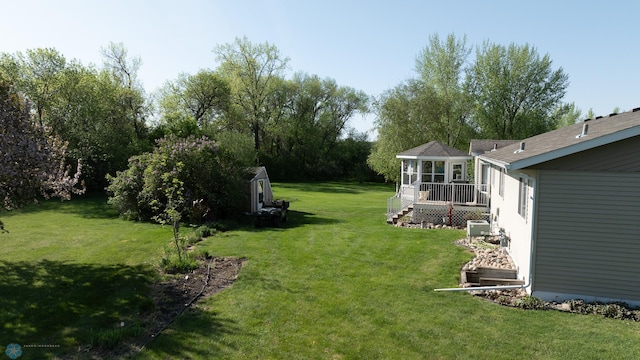 6673 230th St N, Cromwell Twp, MN 56549 - view of grassy yard featuring a sunroom, an outbuilding, and a storage unit