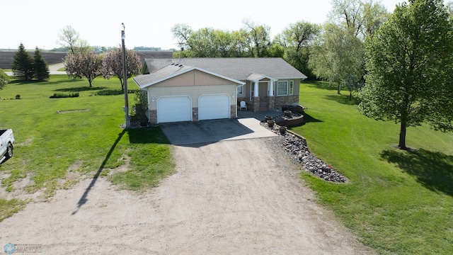 6673 230th St N, Cromwell Twp, MN 56549 - ranch-style house with stone siding, an attached garage, dirt driveway, and a front yard