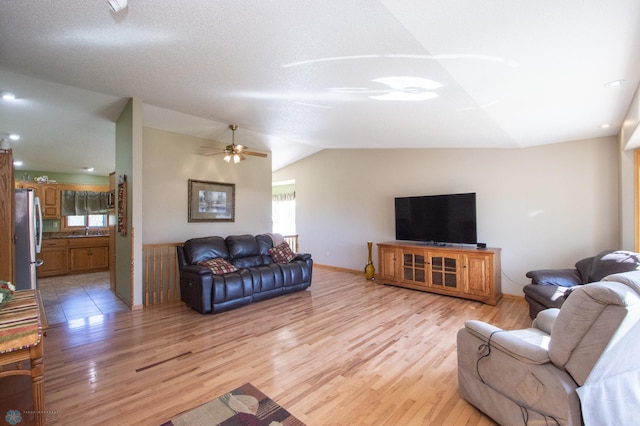 6673 230th St N, Cromwell Twp, MN 56549 - living room with plenty of natural light, light wood-style floors, vaulted ceiling, ceiling fan, and baseboards