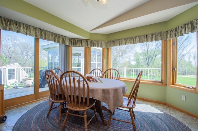 6673 230th St N, Cromwell Twp, MN 56549 - dining space featuring lofted ceiling, tile patterned floors, and baseboards