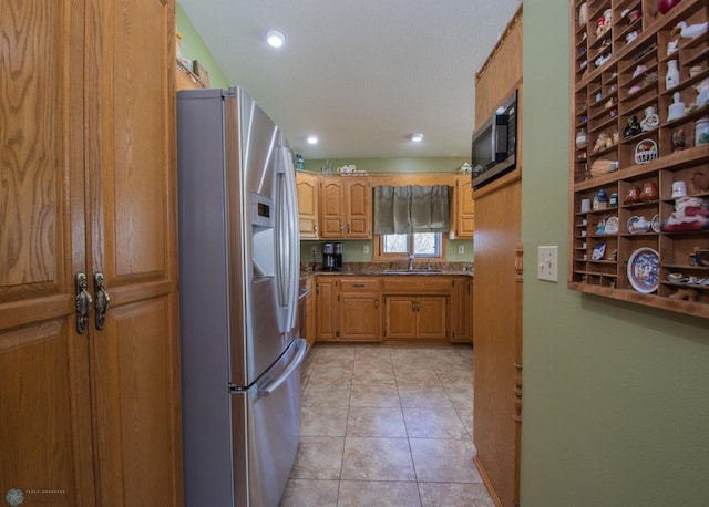 6673 230th St N, Cromwell Twp, MN 56549 - kitchen with stainless steel appliances, a sink, brown cabinets, dark countertops, and recessed lighting