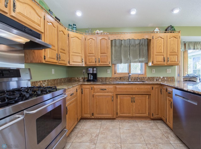 6673 230th St N, Cromwell Twp, MN 56549 - kitchen featuring stainless steel appliances, a sink, under cabinet range hood, dark stone countertops, and recessed lighting