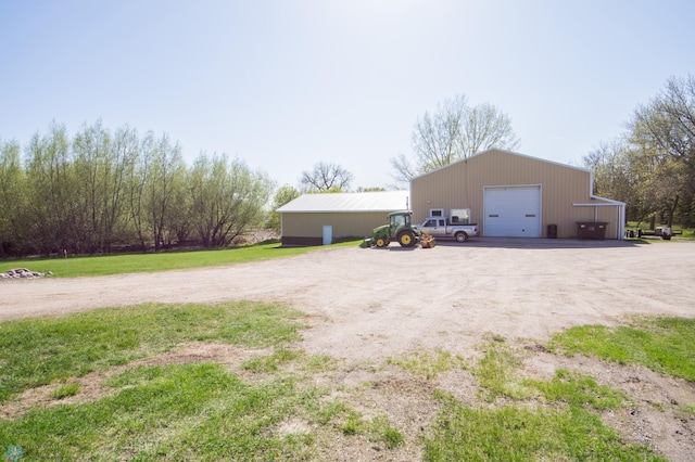 6673 230th St N, Cromwell Twp, MN 56549 - view of yard featuring a garage, an outdoor structure, a pole building, and driveway