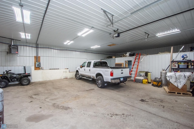 6673 230th St N, Cromwell Twp, MN 56549 - garage featuring a garage door opener and metal wall