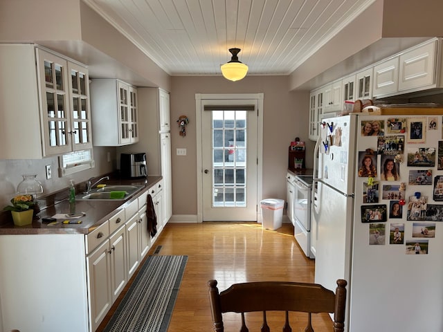 12176 2nd St, Northome, MN 56661 - kitchen featuring white appliances, ornamental molding, white cabinets, light wood-style floors, and glass insert cabinets