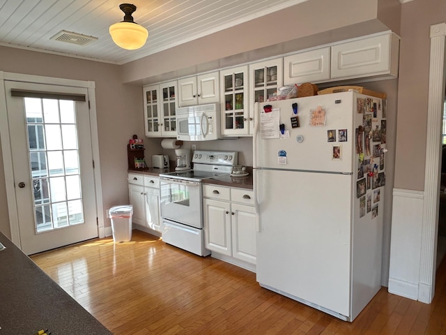 12176 2nd St, Northome, MN 56661 - kitchen with white appliances, dark countertops, light wood finished floors, white cabinetry, and crown molding