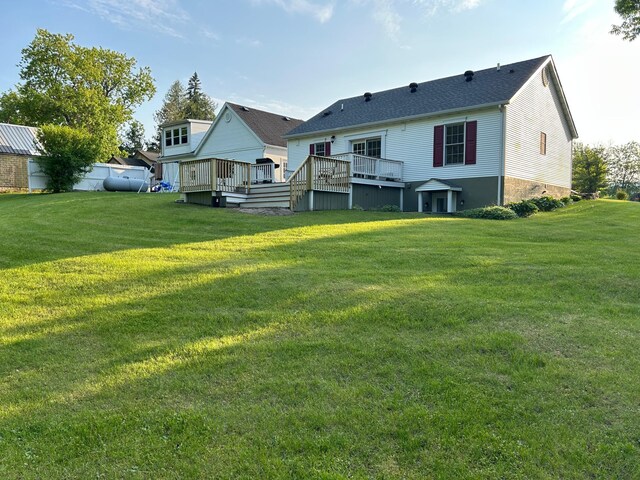 12176 2nd St, Northome, MN 56661 - back of house with a wooden deck and a lawn