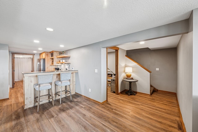 49935 Acacia Trl, Nessel Twp, MN 55080 - kitchen with freestanding refrigerator, open shelves, wood finished floors, baseboards, and recessed lighting