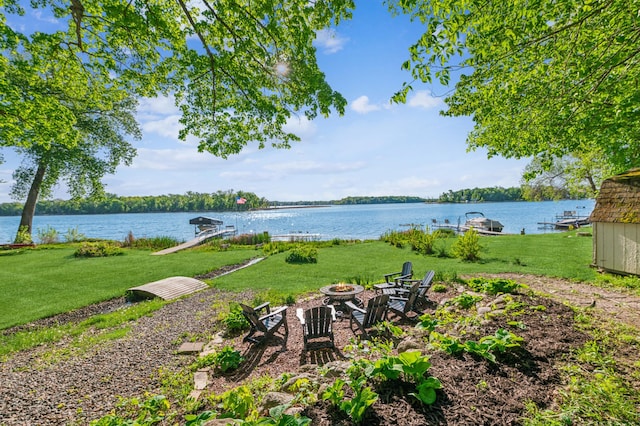 49935 Acacia Trl, Nessel Twp, MN 55080 - view of grassy yard featuring an outdoor fire pit, a water view, and a dock