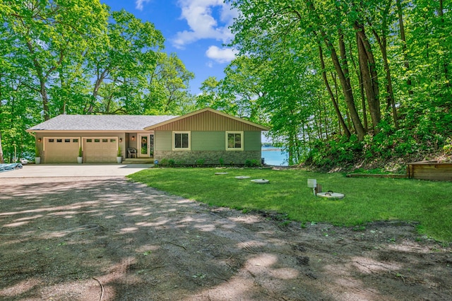 49935 Acacia Trl, Nessel Twp, MN 55080 - view of front of house with a garage, driveway, a front yard, and stone siding