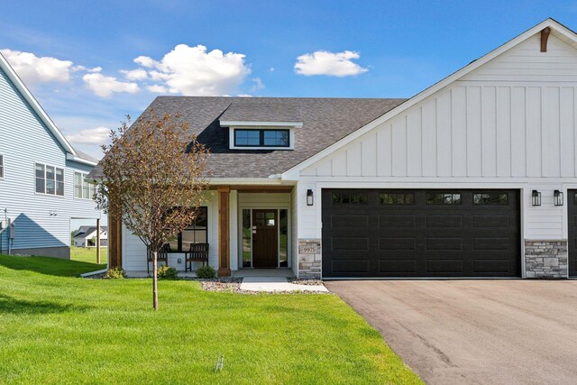 9975 Kari Way, Elko New Market, MN 55020 - modern inspired farmhouse with a shingled roof, board and batten siding, stone siding, a front yard, and asphalt driveway