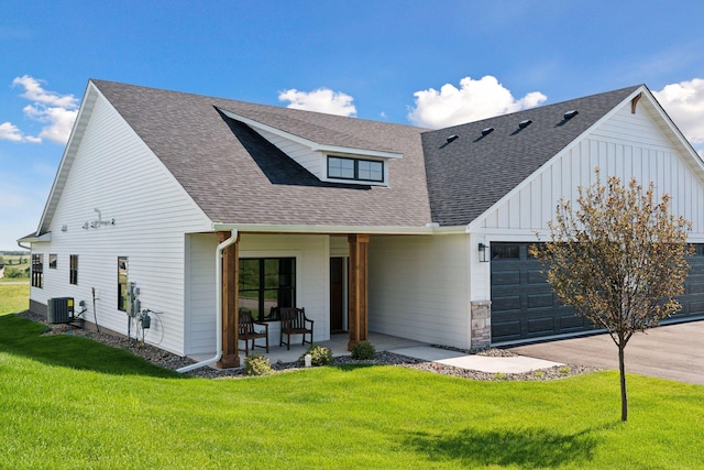 9975 Kari Way, Elko New Market, MN 55020 - modern farmhouse with central AC, an attached garage, a shingled roof, a front lawn, and board and batten siding