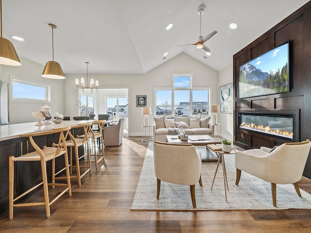 9975 Kari Way, Elko New Market, MN 55020 - living room with a fireplace, a ceiling fan, dark wood finished floors, a chandelier, and high vaulted ceiling