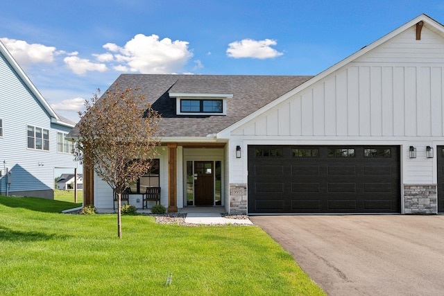 9975 Kari Way, Elko New Market, MN 55020 - modern farmhouse style home featuring a shingled roof, board and batten siding, stone siding, a front yard, and asphalt driveway