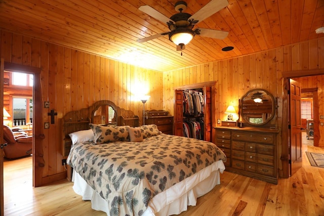 7236 Far N Rd, Buyck, MN 55771 - bedroom featuring wooden ceiling, light wood-type flooring, wood walls, a closet, and a walk in closet