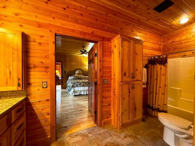 7236 Far N Rd, Buyck, MN 55771 - full bathroom featuring wooden walls, toilet, shower / bath combo with shower curtain, vanity, and wooden ceiling