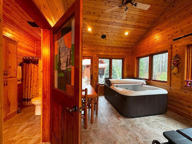 7236 Far N Rd, Buyck, MN 55771 - bathroom with vaulted ceiling, ceiling fan, wood walls, toilet, and wood ceiling