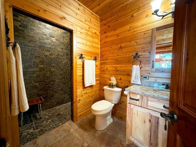 7236 Far N Rd, Buyck, MN 55771 - full bathroom with walk in shower, toilet, vanity, wooden walls, and tile patterned flooring