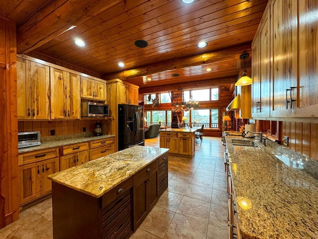7236 Far N Rd, Buyck, MN 55771 - kitchen featuring a center island, black fridge, stainless steel microwave, wooden ceiling, and brown cabinets