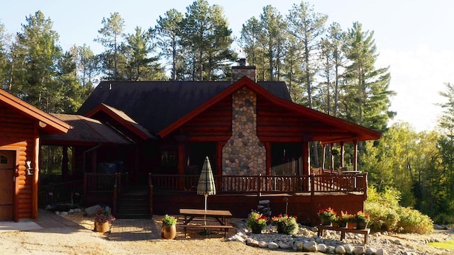 7236 Far N Rd, Buyck, MN 55771 - log home featuring a chimney and a wooden deck