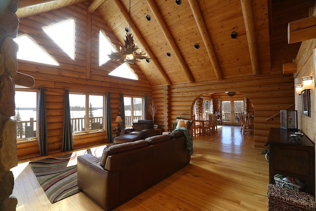 3165 Randa Rd, Orr, MN 55771 - living area with arched walkways, wooden ceiling, beamed ceiling, light wood-style floors, and healthy amount of natural light