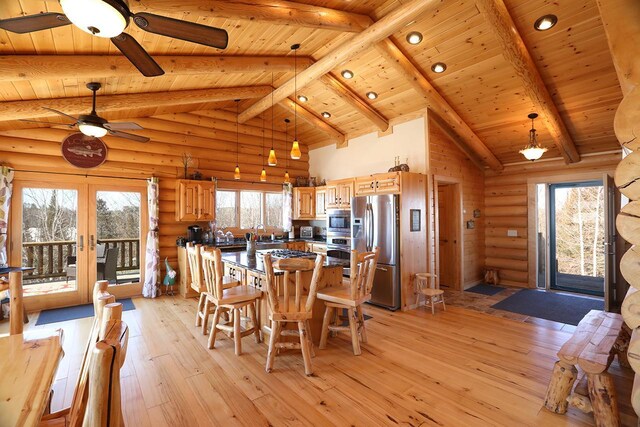3165 Randa Rd, Orr, MN 55771 - dining space featuring a ceiling fan, wooden ceiling, light wood-style floors, beam ceiling, and high vaulted ceiling