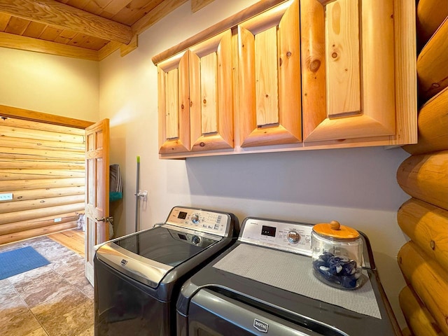 3165 Randa Rd, Orr, MN 55771 - washroom featuring washer and clothes dryer, wood ceiling, log walls, and cabinet space