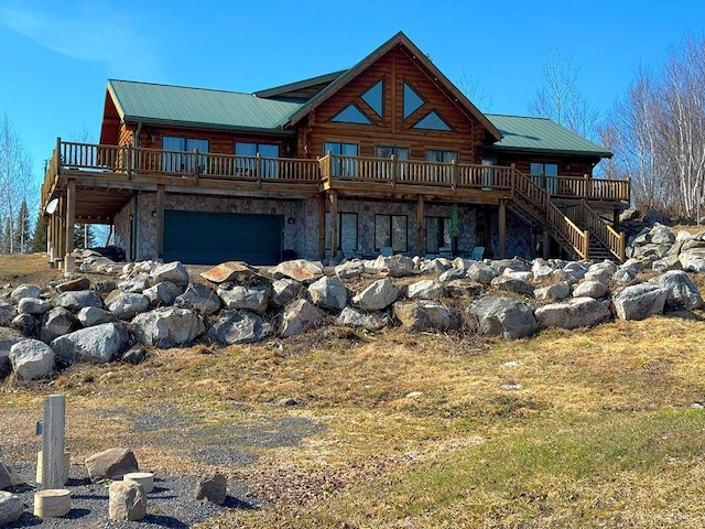 3165 Randa Rd, Orr, MN 55771 - back of house featuring a wooden deck, stone siding, metal roof, and log siding