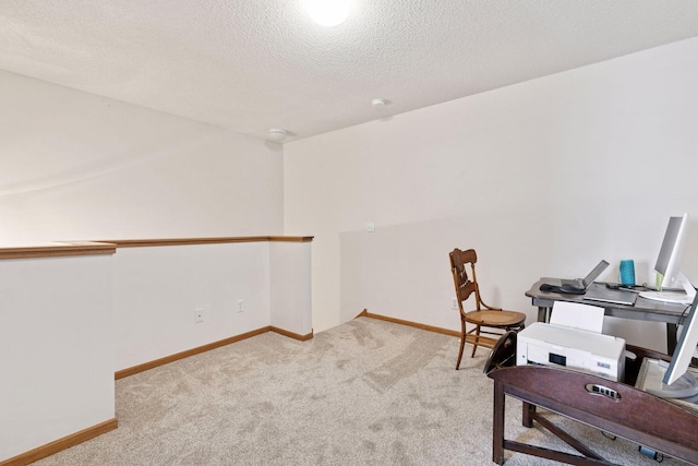 home office featuring carpet floors, baseboards, and a textured ceiling