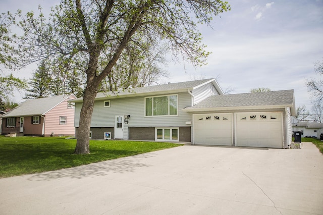 bi-level home featuring driveway, a garage, a front lawn, brick siding, and a shingled roof