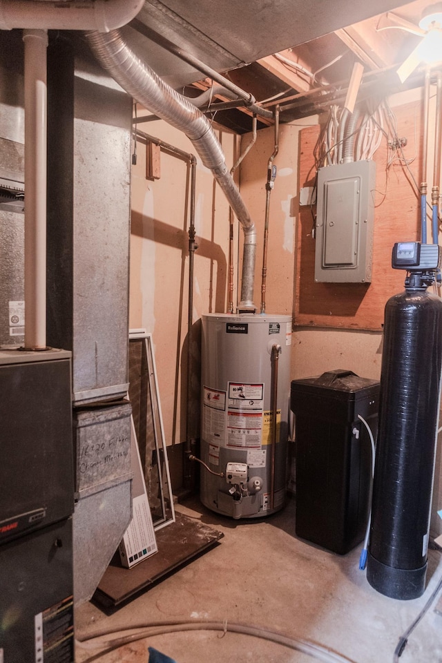 utility room featuring gas water heater, electric panel, and heating unit