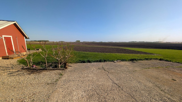 view of yard featuring a view of countryside and an outdoor structure
