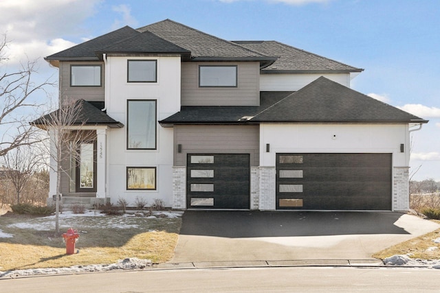 12745 Stutz Ct NE, Blaine, MN 55449 - view of front facade featuring asphalt driveway, a garage, and a shingled roof