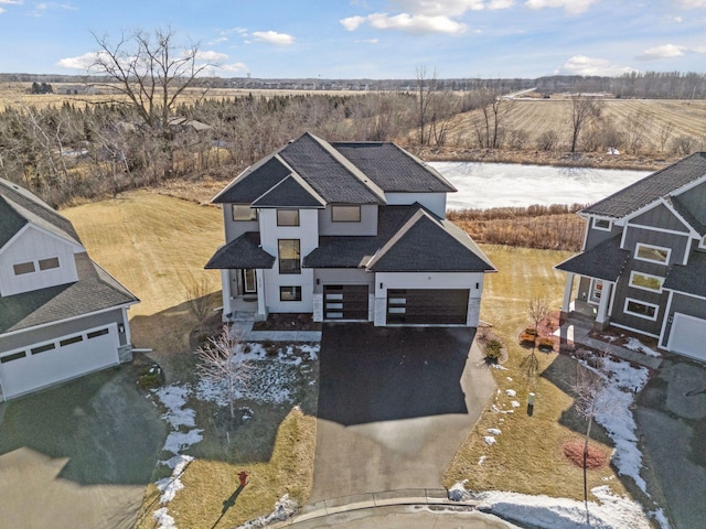 12745 Stutz Ct NE, Blaine, MN 55449 - view of front of property with driveway, a garage, and a rural view